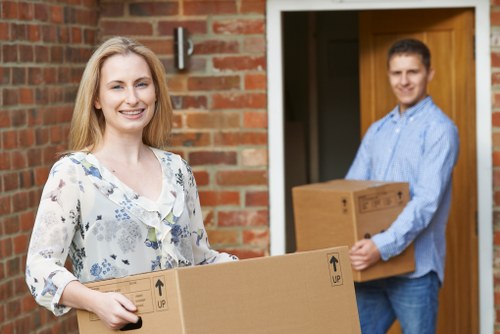 Helper loading boxes and household items for a Bromley move