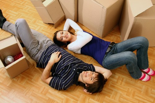 Local piano movers navigating a tight staircase in Bromley